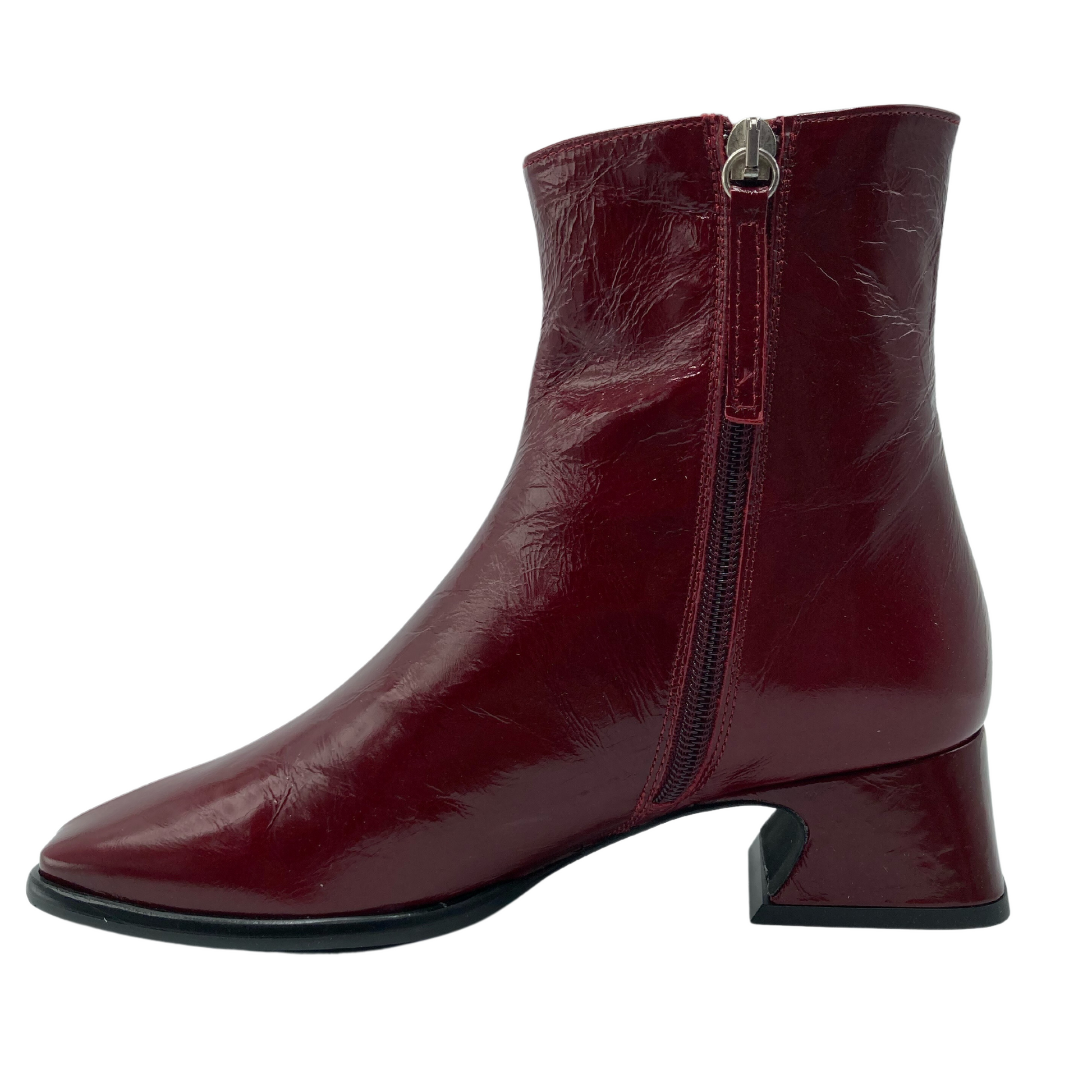 Left facing view of red leather short boot with side zipper closure