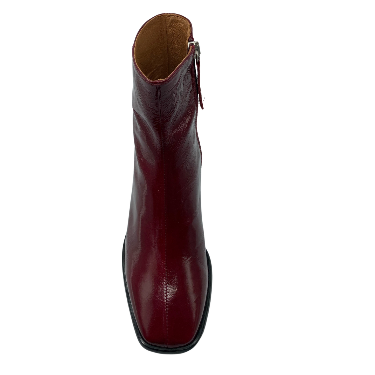 Top facing view of red leather boot with square toe and side zipper closure