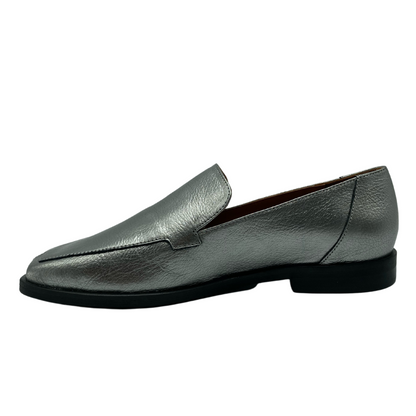 Left facing view of silver leather loafer with black outsole