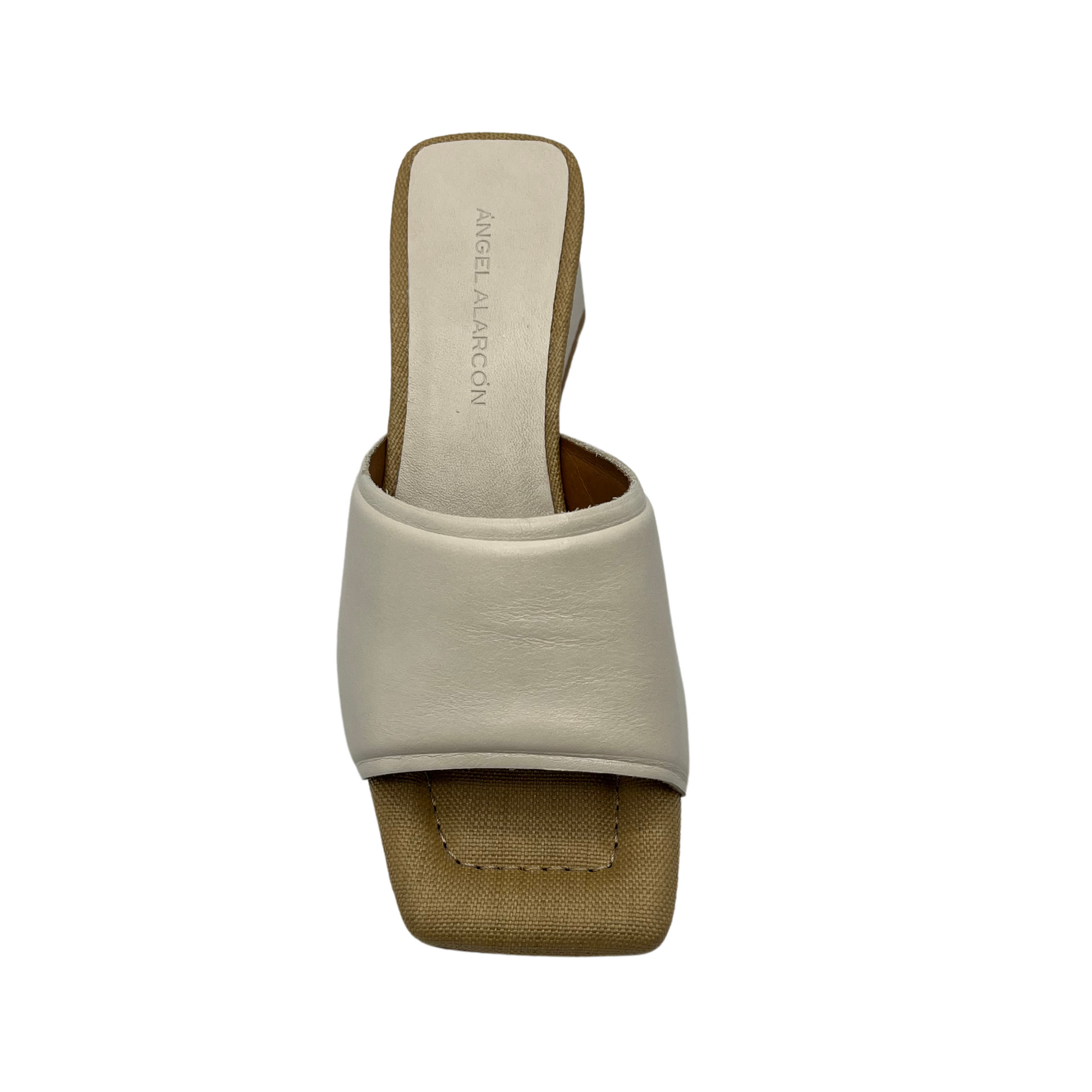Top view of cream coloured leather slip on sandal with square toe, wrapped block heel and padded insole
