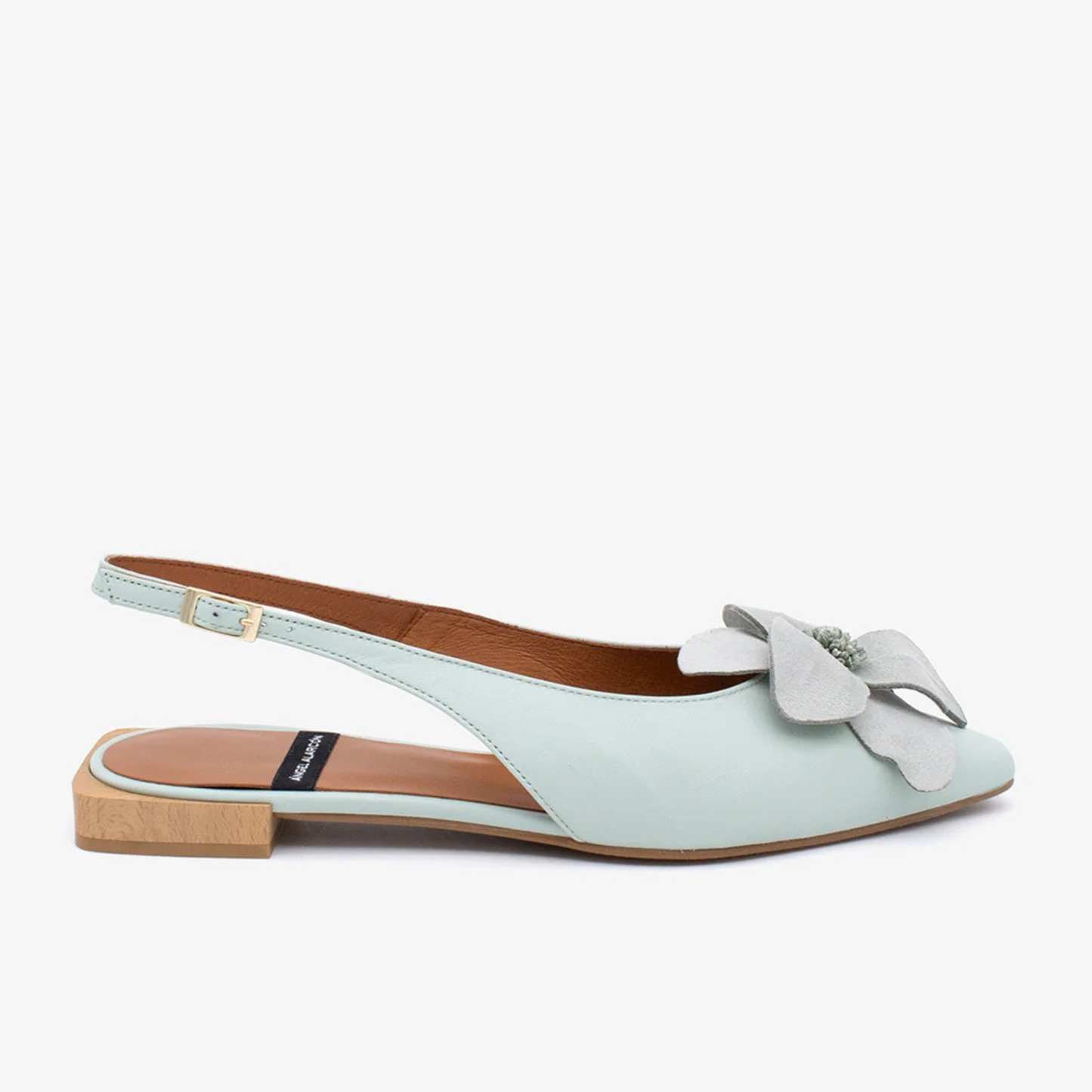 Light blue flat sandal with a bow on a white background