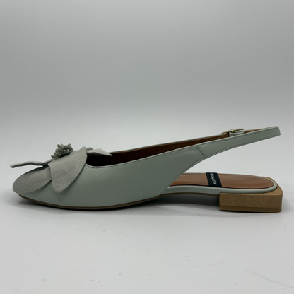 Light green slingback shoe with a bow on a white background