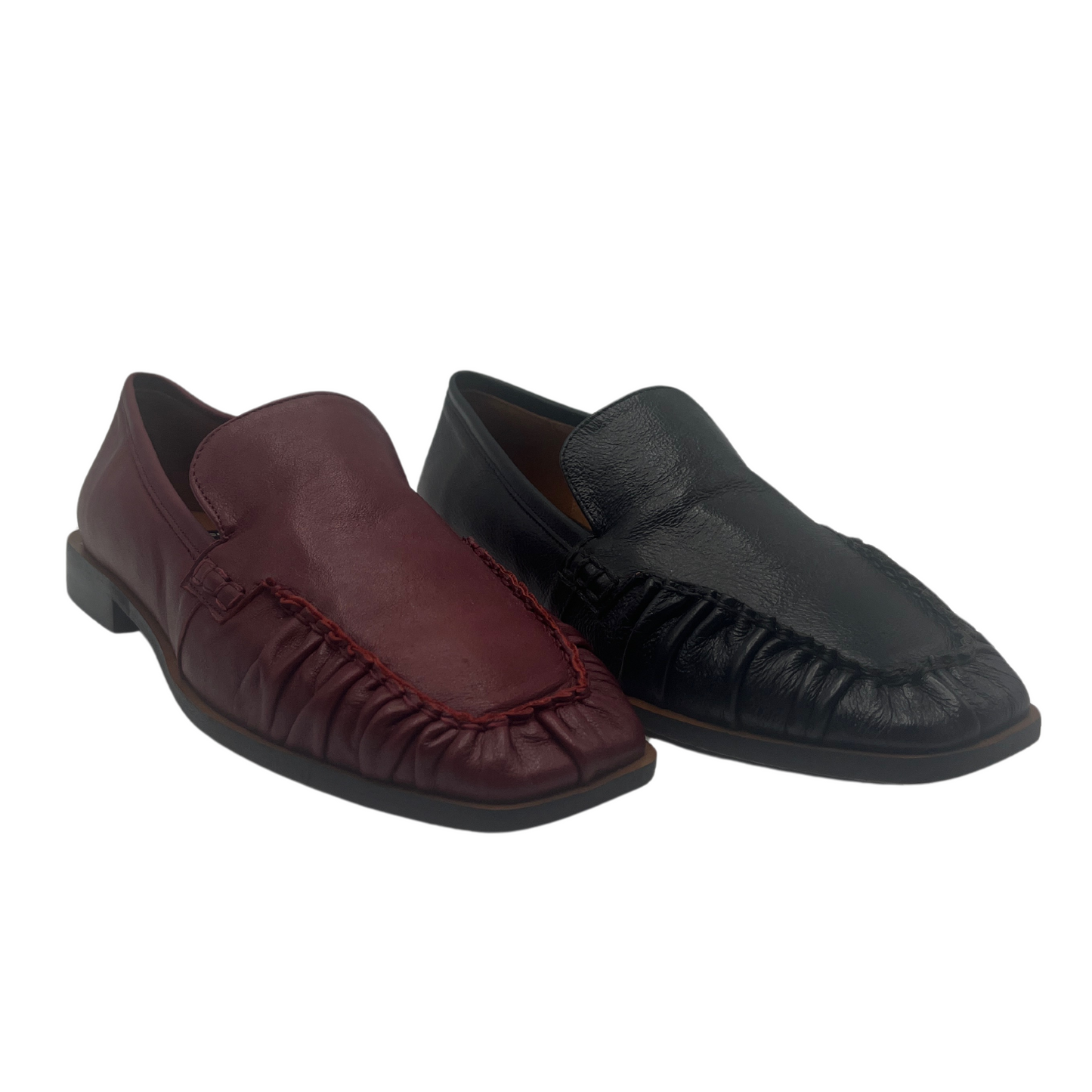 View of a pair of leather loafers one is red and one is black. Both have square toes and short block heels
