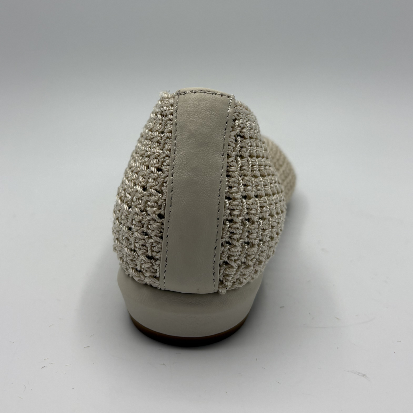 Beige woven shoe on a white background