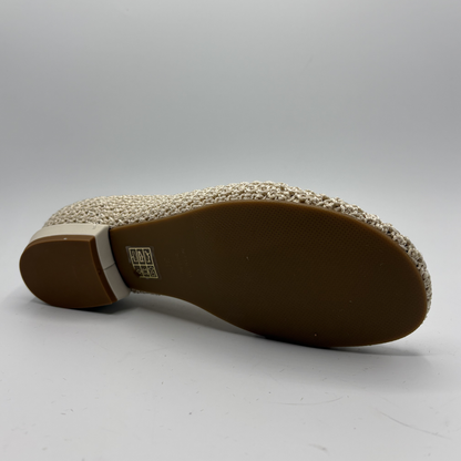 Close-up of a shoe sole with a textured pattern on a gray background