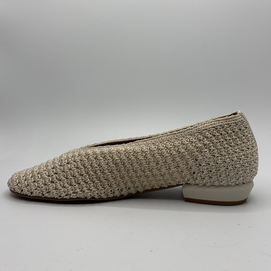 Beige textured flat shoe on a gray background