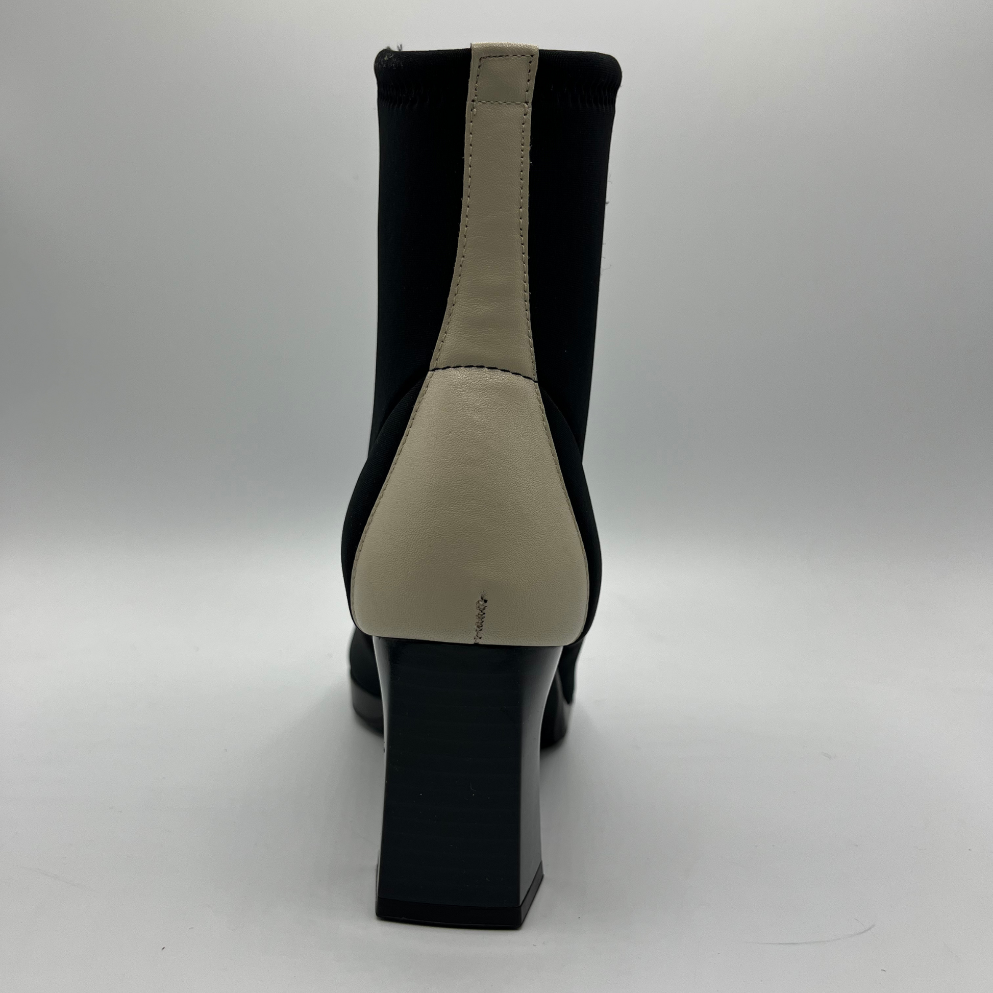 Black ankle boot with beige heel on a white background
