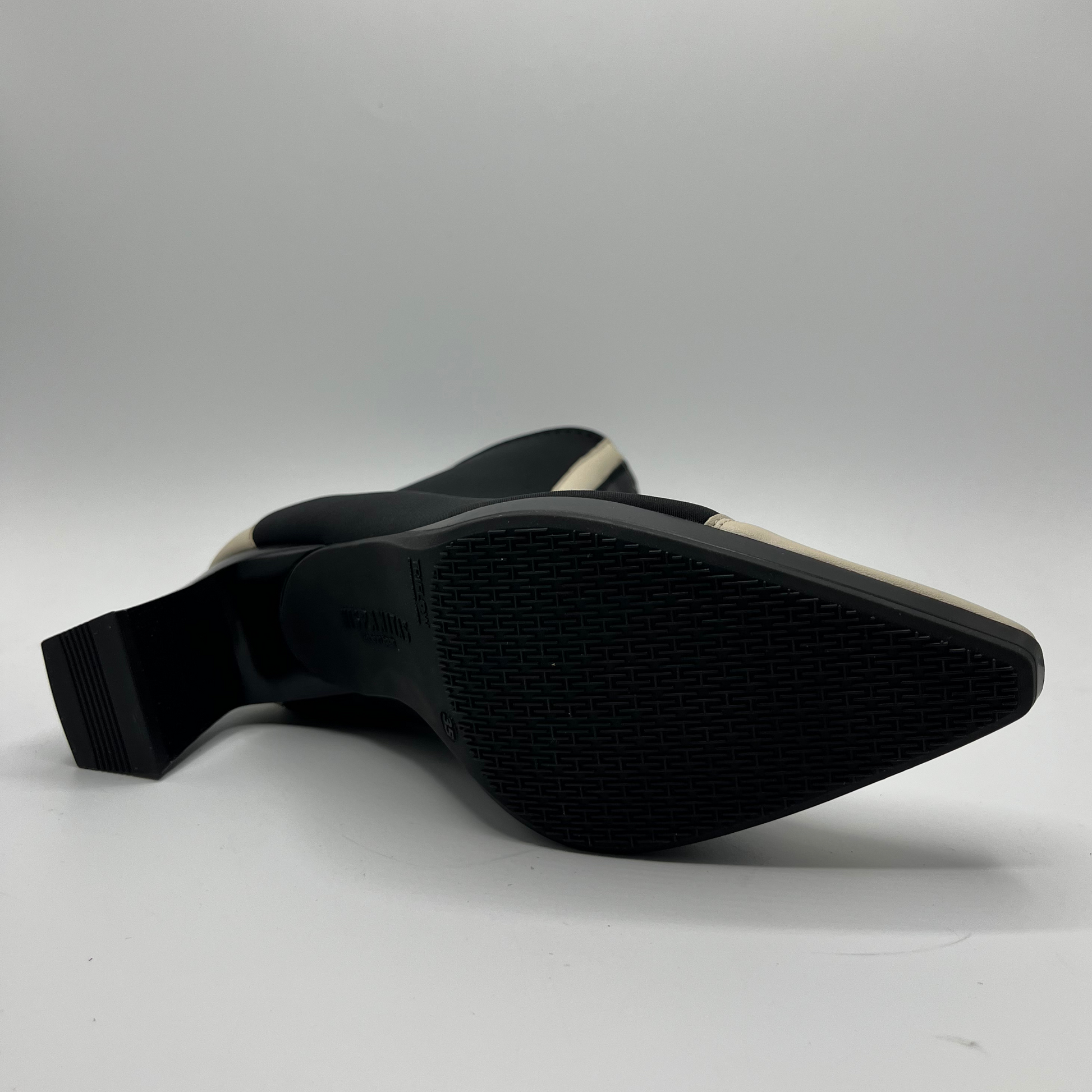 Black shoe sole with textured surface on a white background