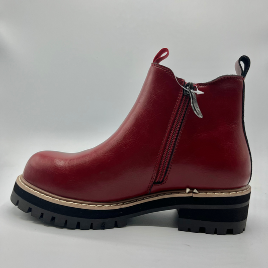 Red leather boot with a zipper on a white background