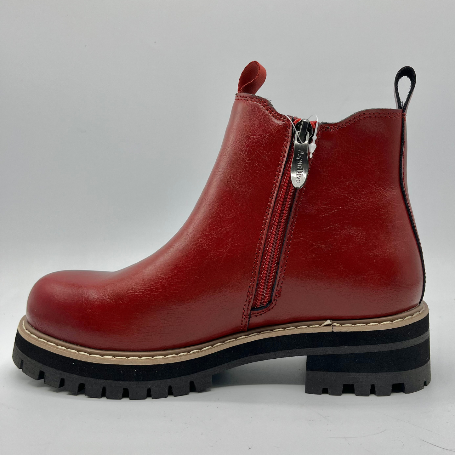 Red leather boot with a zipper on a gray background