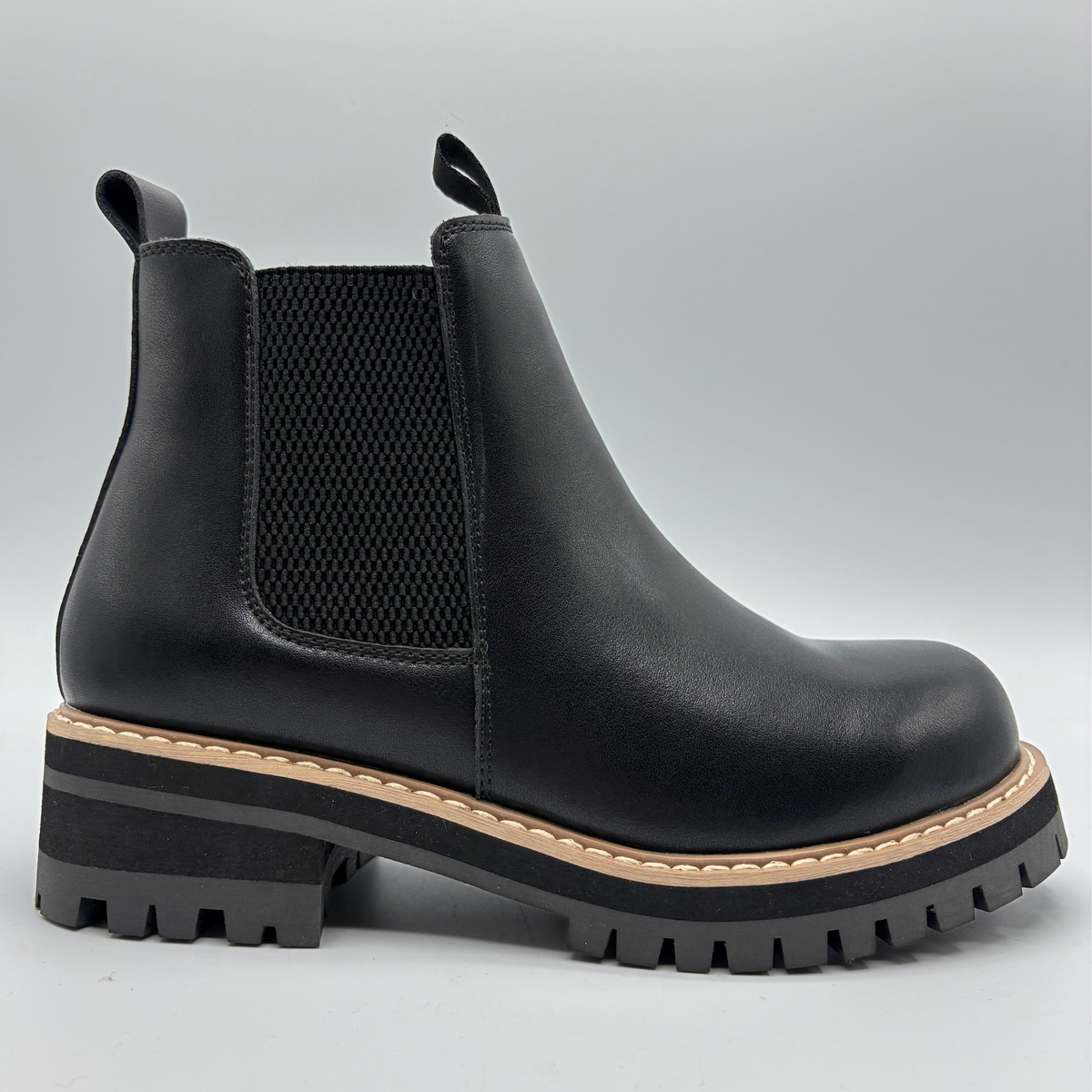 Right facing view of a black chelsea boot with an elastic side gore
