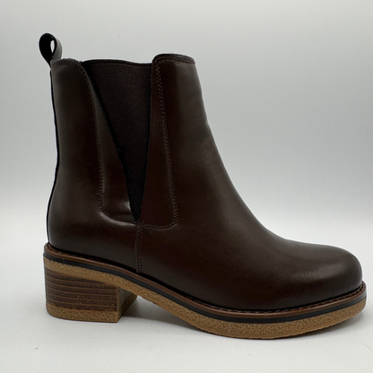 Right facing view of a brown chelsea boot with a pull on heel tab