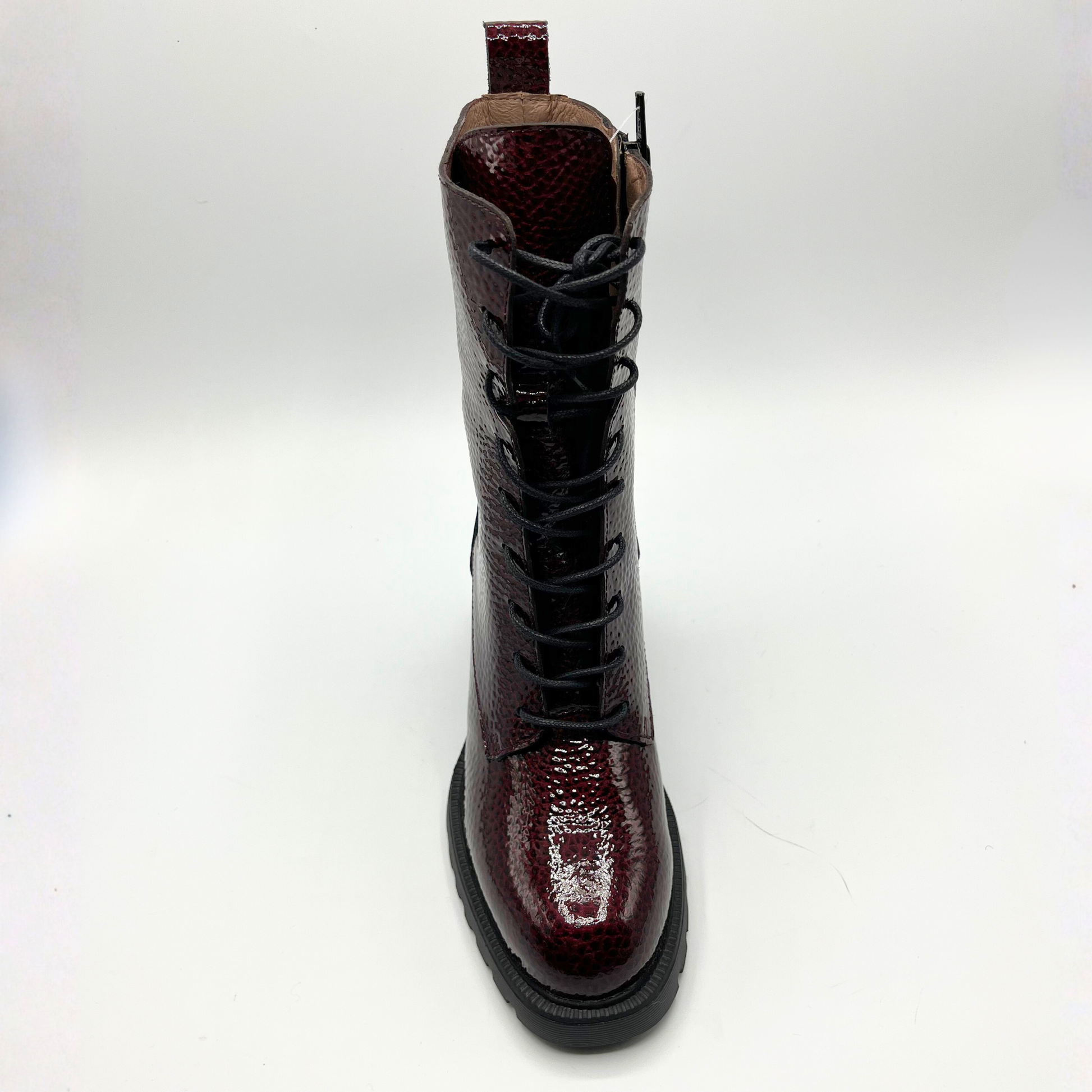 Brown leather boot with a glossy finish on a white background