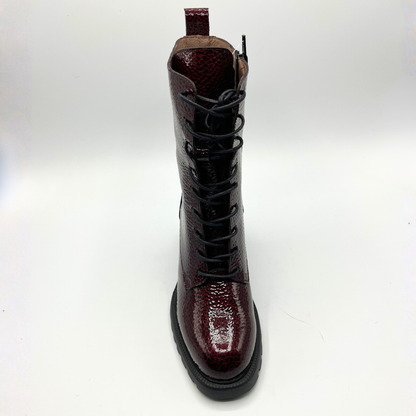 Brown leather boot with a glossy finish on a white background