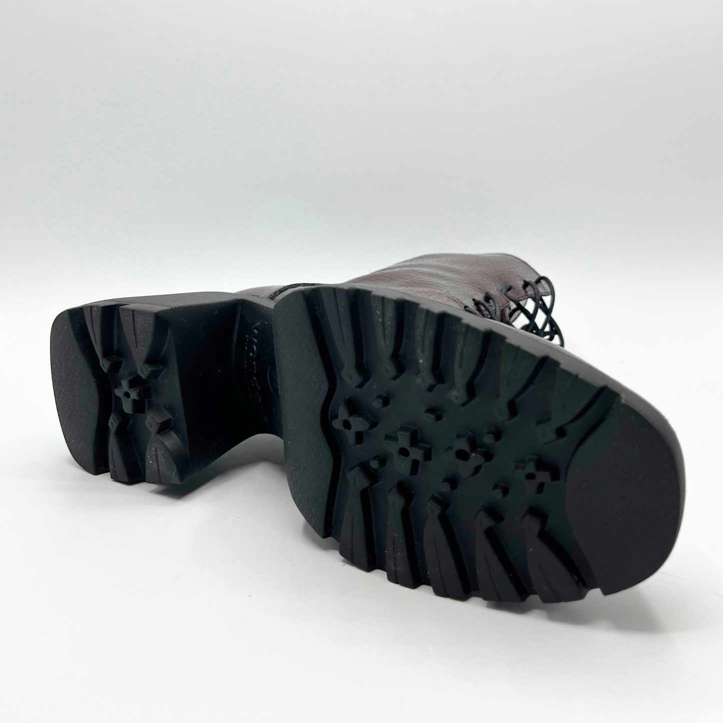 Close-up of a black rubber sole on a white background