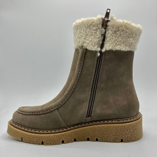 Brown suede boot with white fur lining on a light gray background