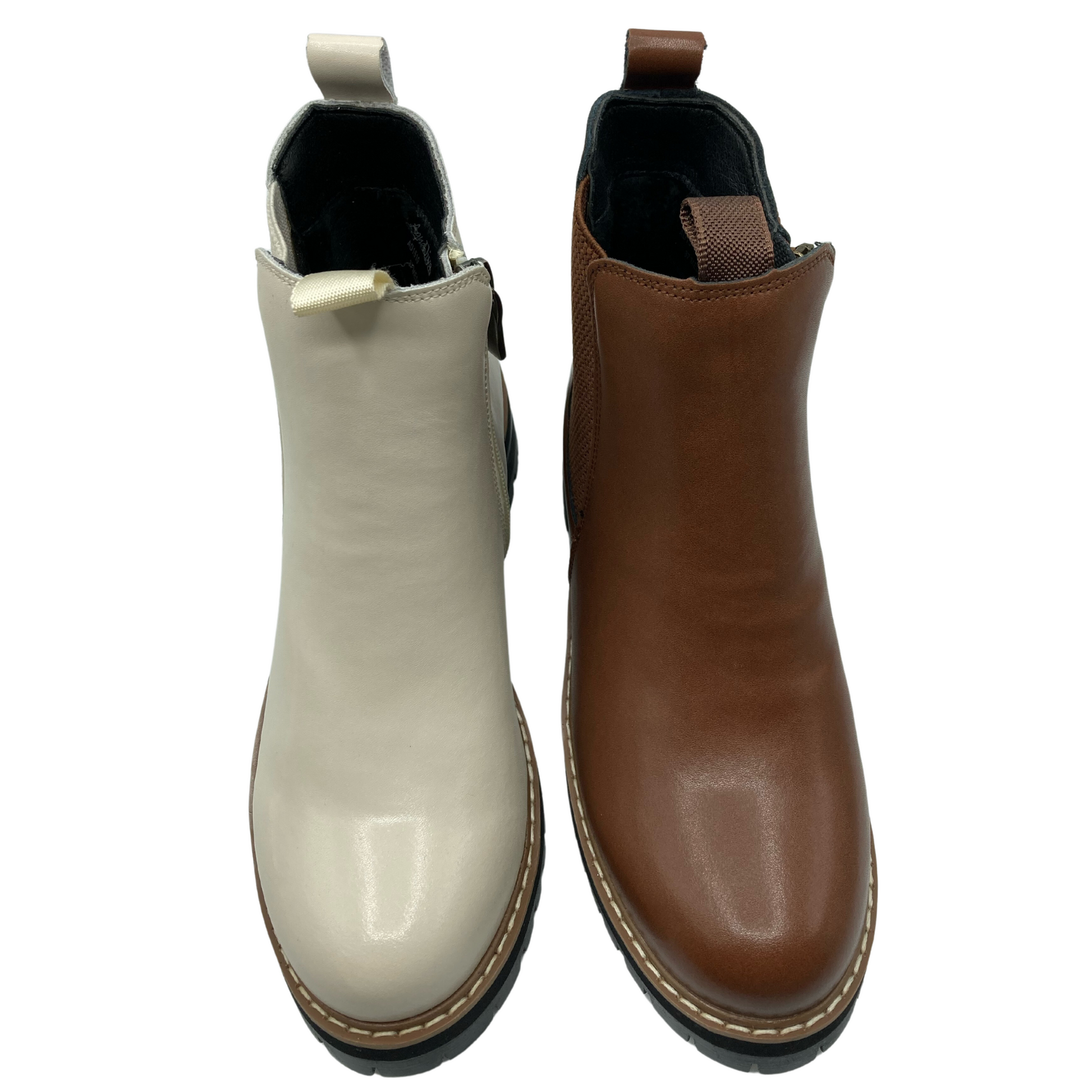 Top view of two ankle boots, the one on the left is beige and the one on the right is light brown. Both have double pull tabs on the upper shaft and rounded toes