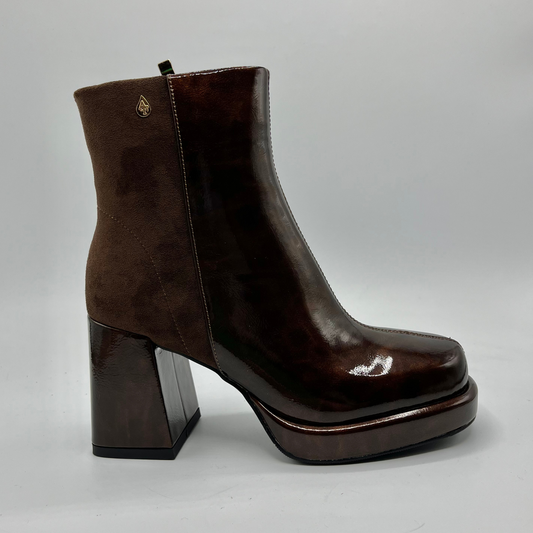 Brown platform ankle boot on a gray background