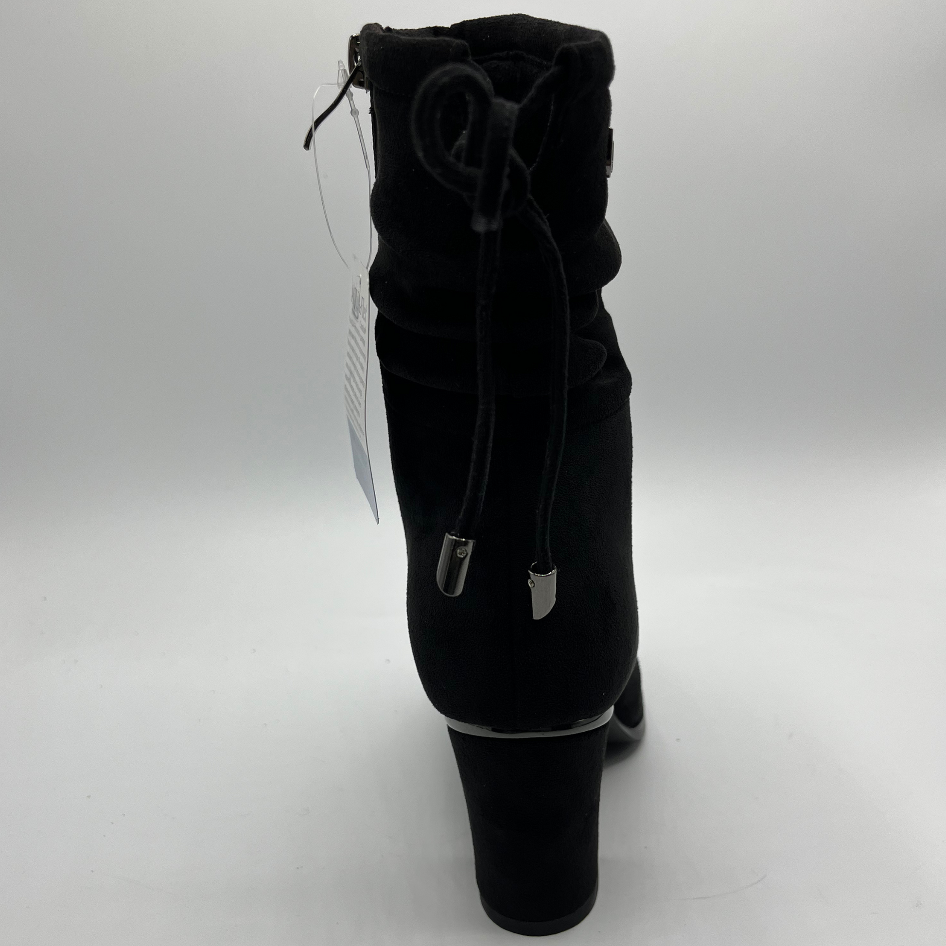 Black ankle boot with a tag on a white background