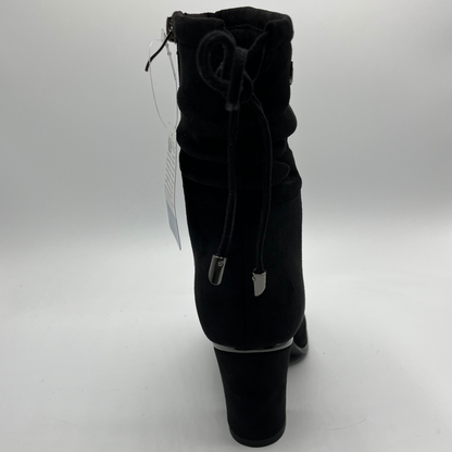 Black ankle boot with a tag on a white background