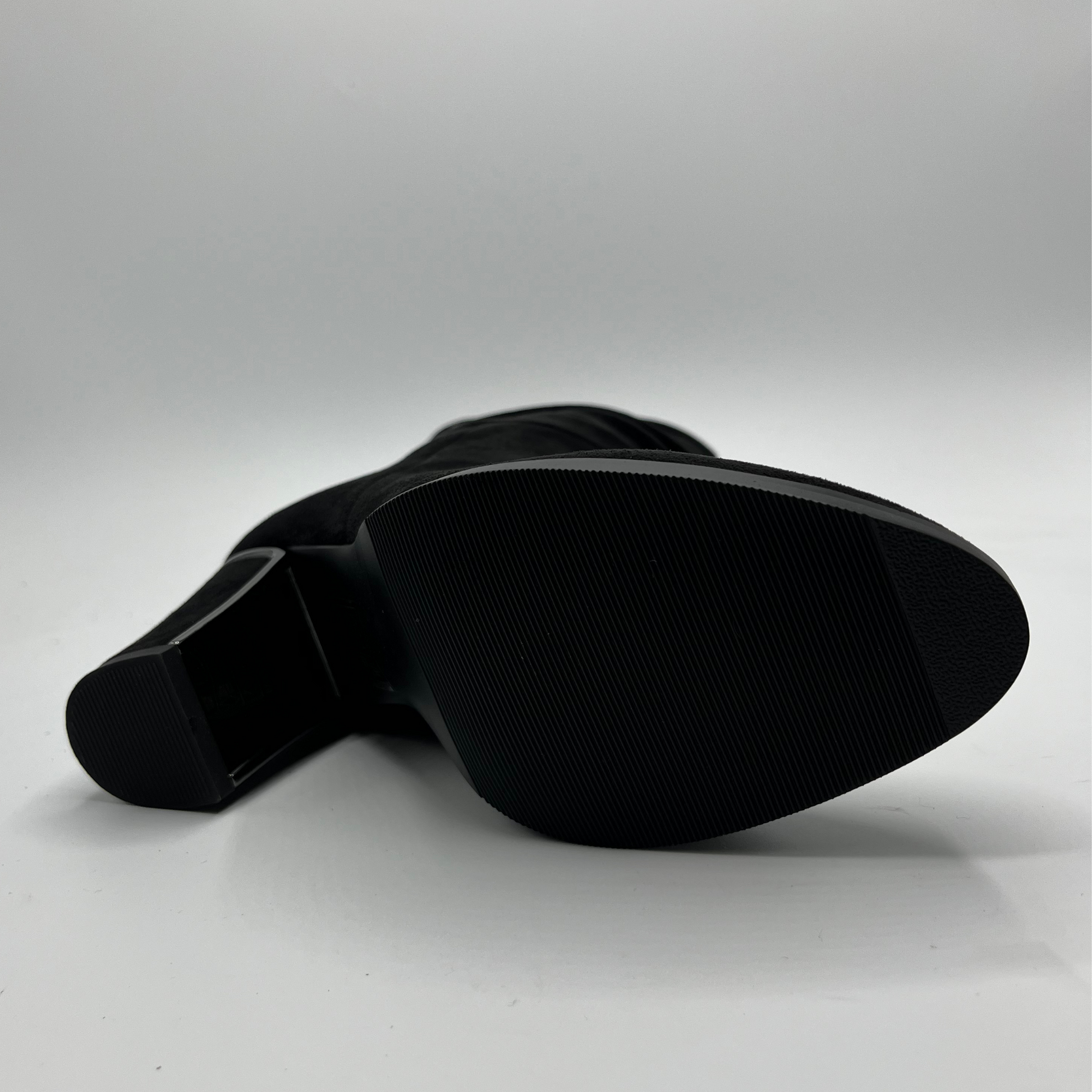 Black shoe sole on a light gray background