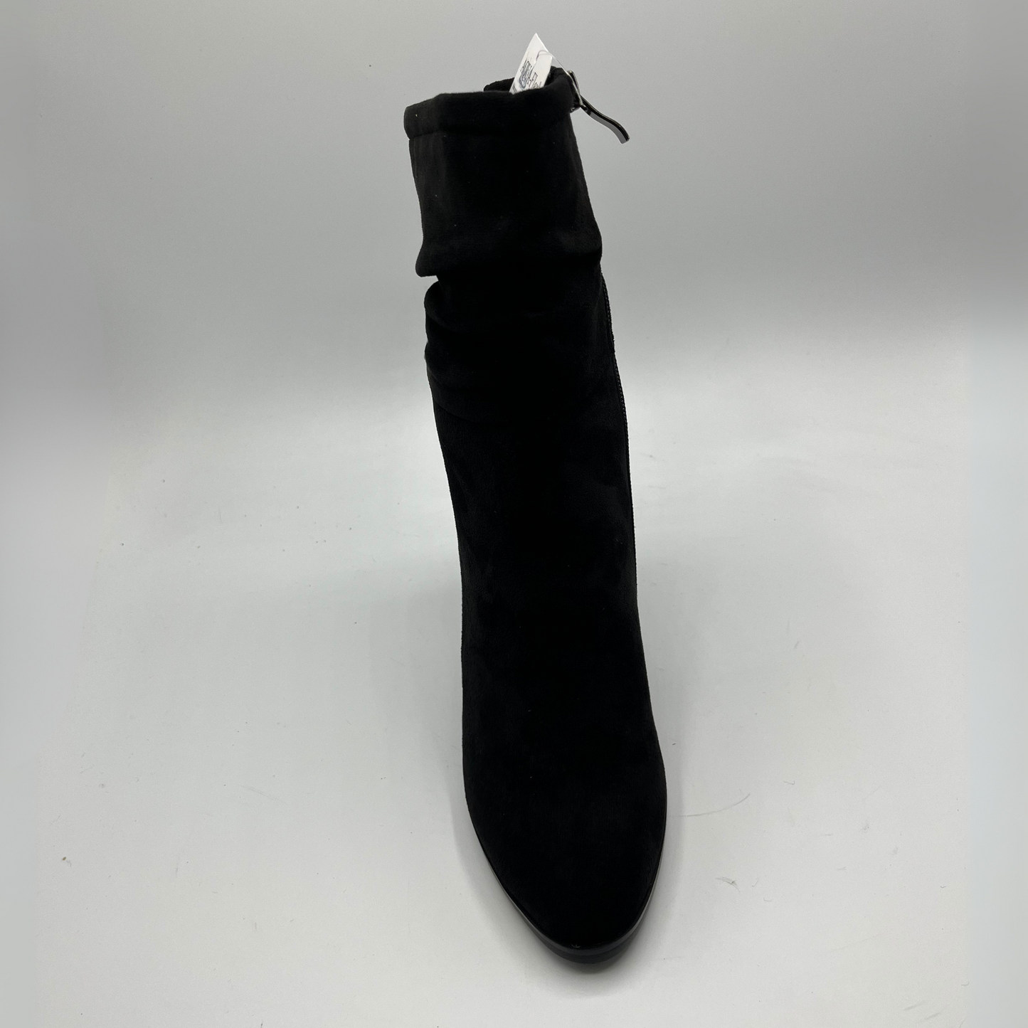 Black ankle boot on a light gray background