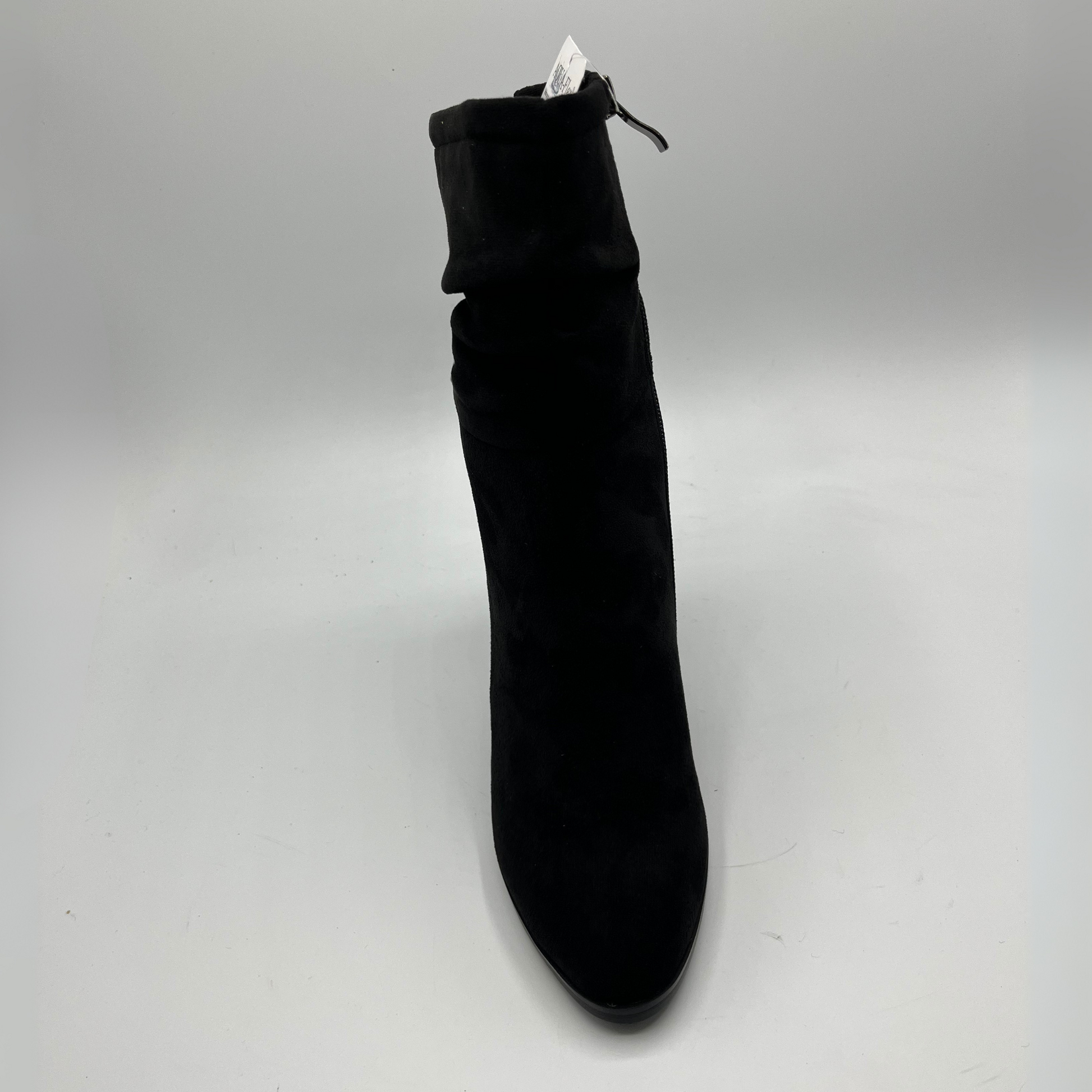 Black ankle boot on a light gray background