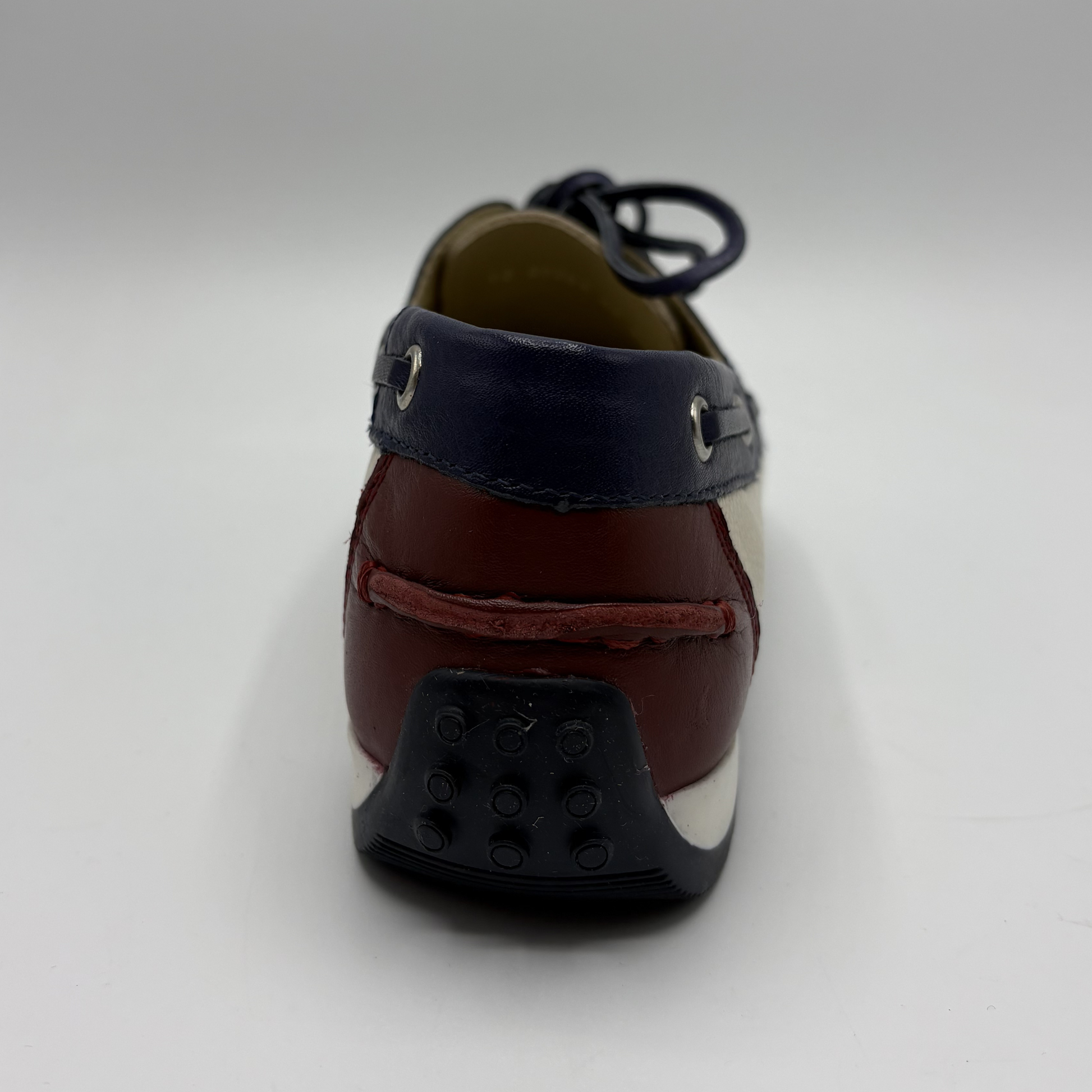 Brown shoe with a black sole on a white background