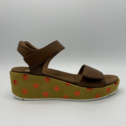 Brown sandal with a polka dot platform on a white background