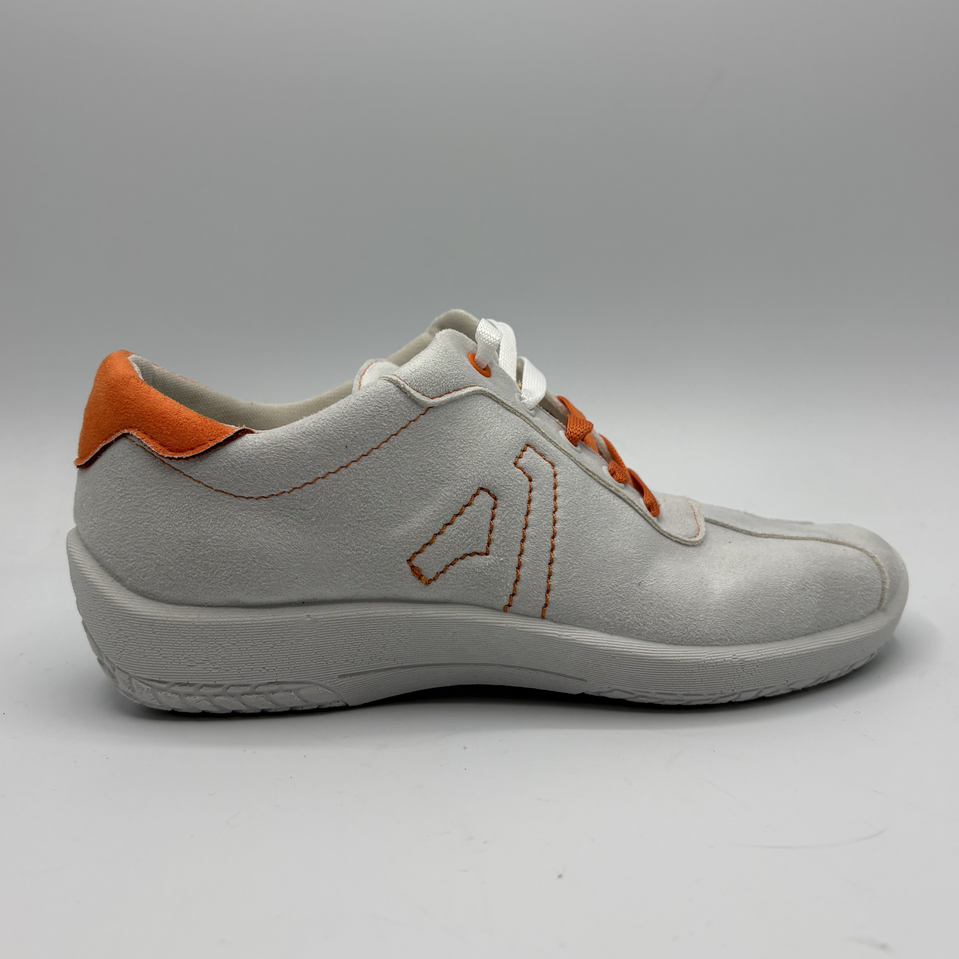 Gray shoe with orange accents on a gray background