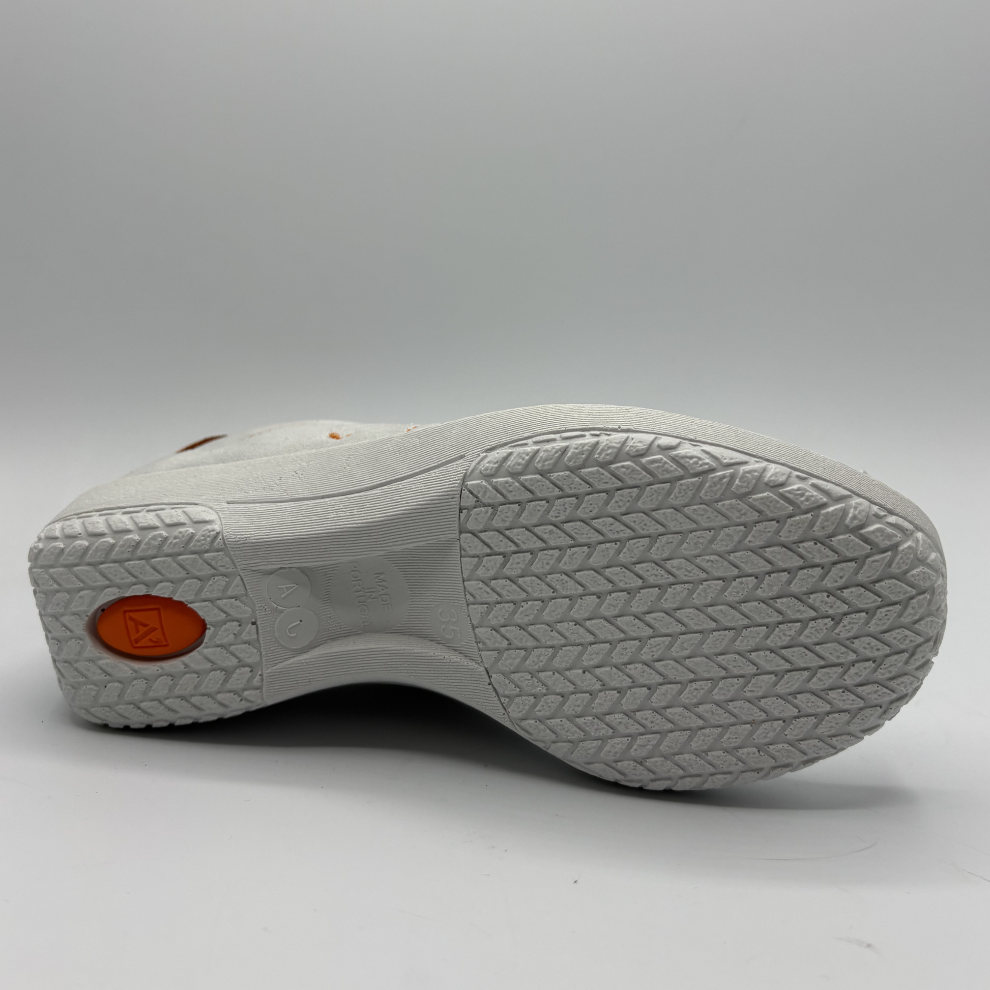 White shoe sole with textured pattern on a gray background