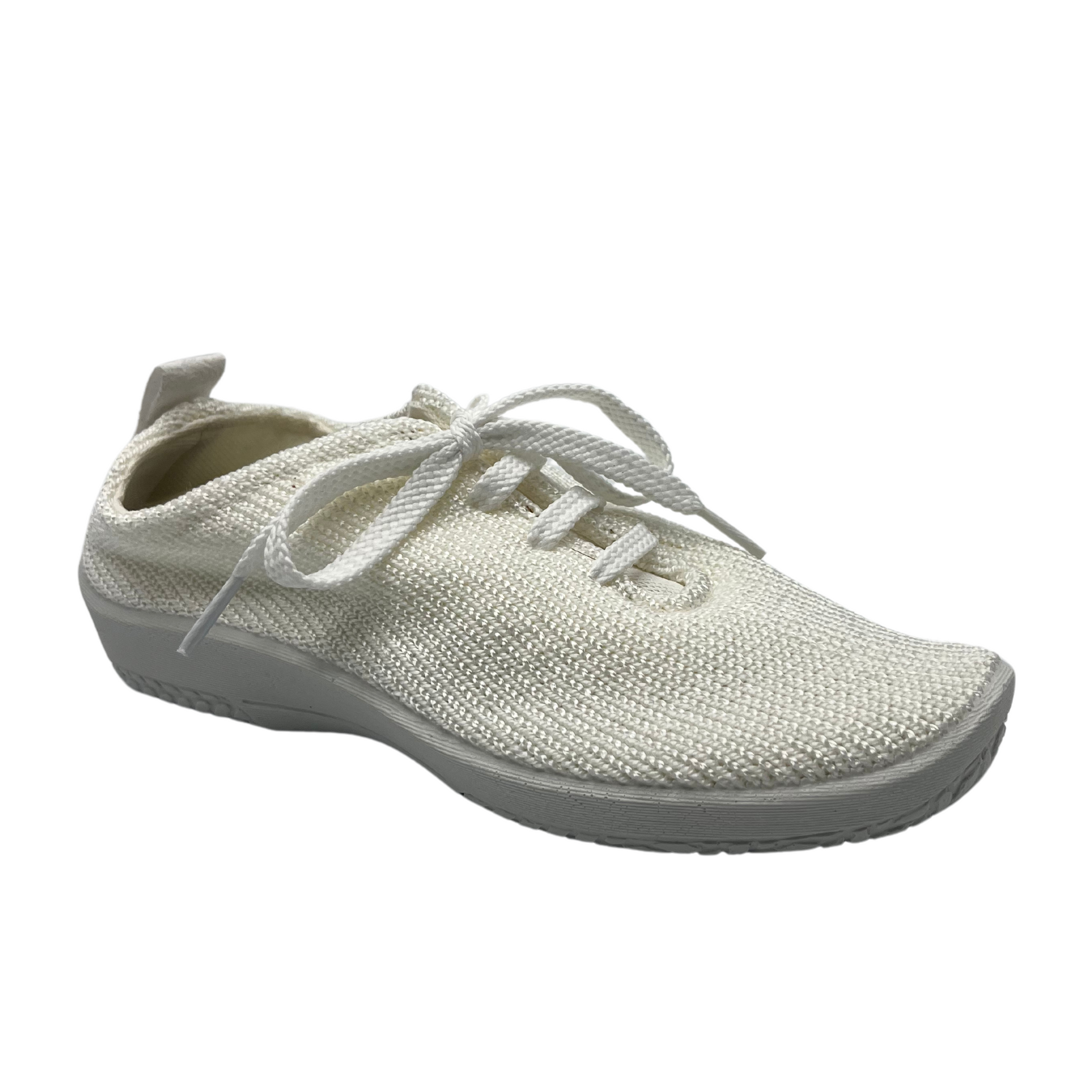 45 degree angled view of white knit upper sneakers with matching laces and outsole