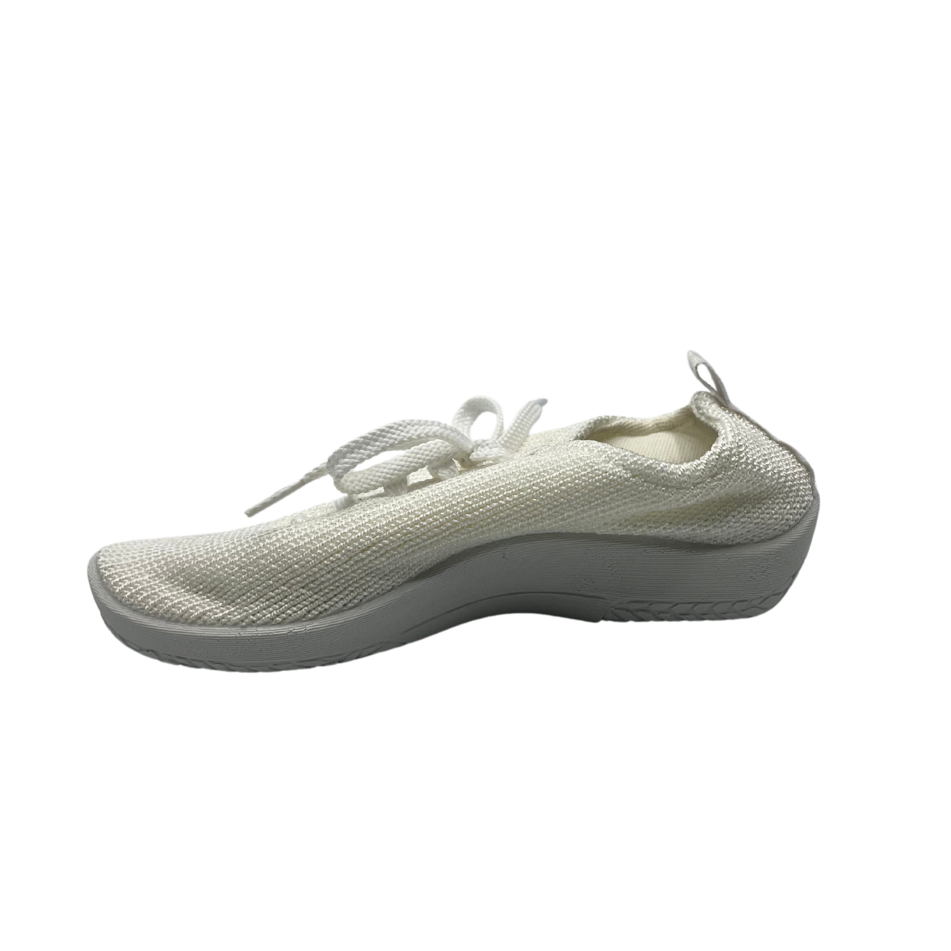 Left view of white knit upper sneakers with matching laces and outsole