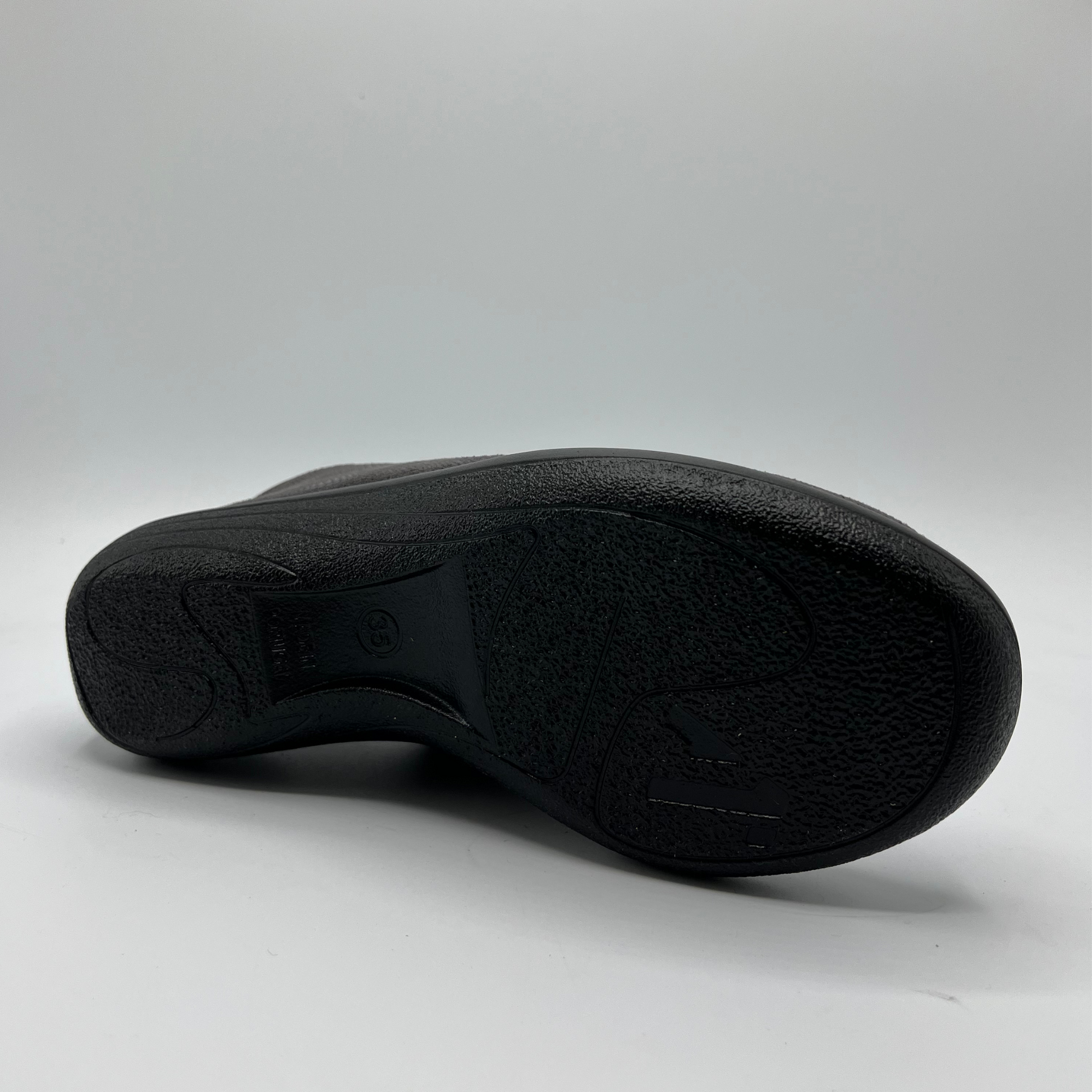 Back view of a grey lace up sneaker with a perforated upper.