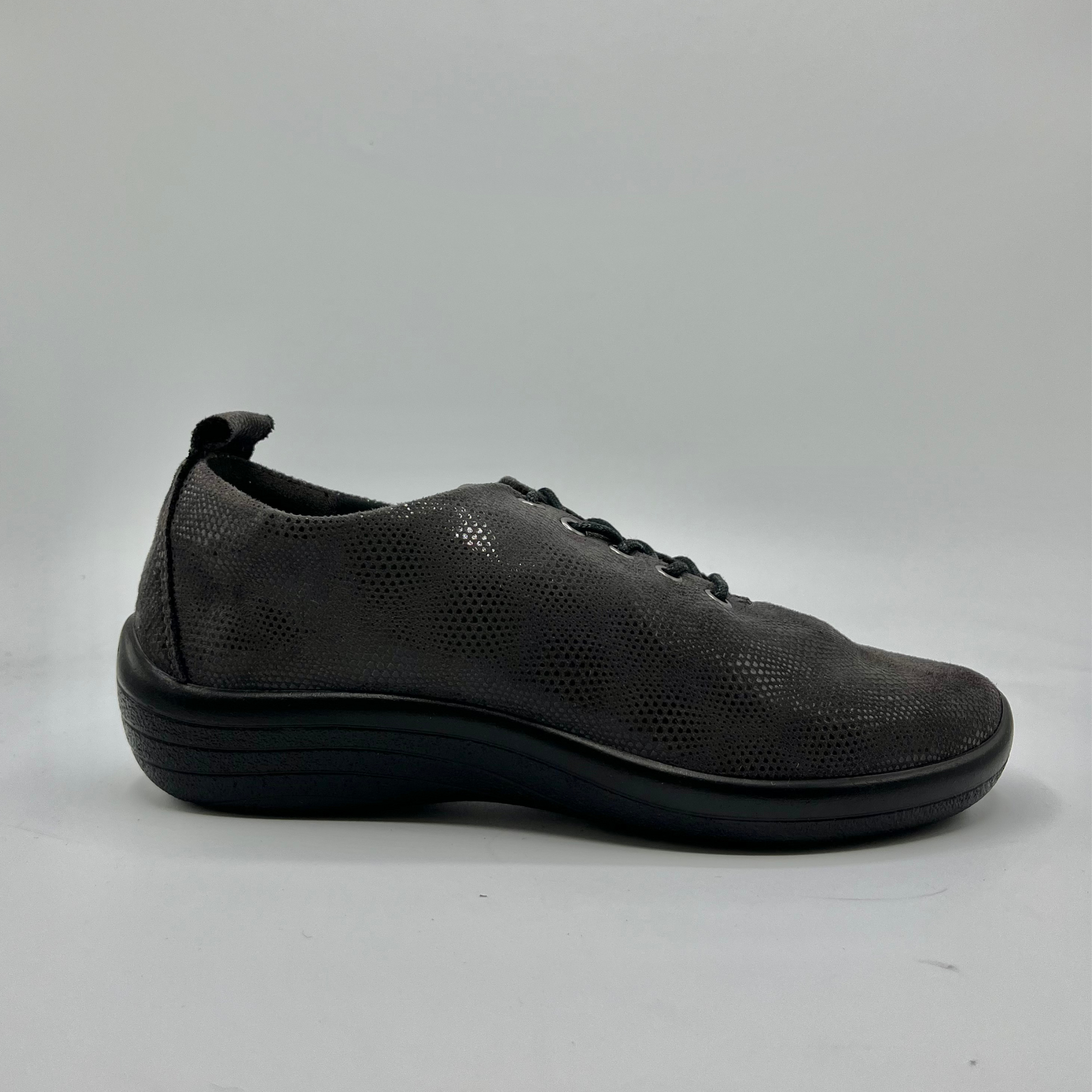 Right facing view of a grey lace up sneaker with a perforated upper.
