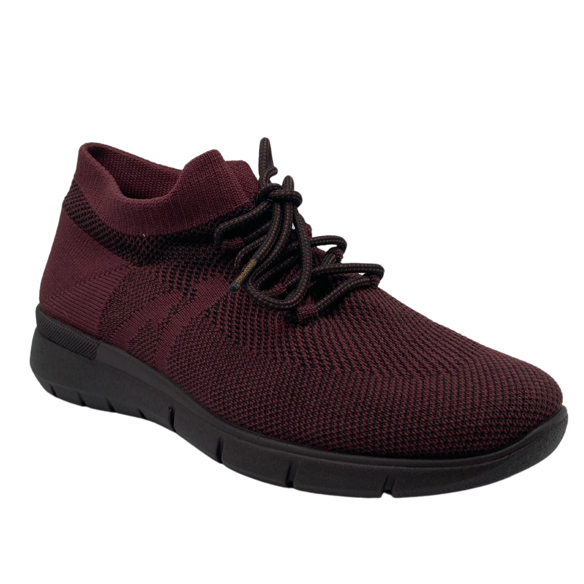 45 degree angled view of wine coloured mesh sneaker with matching laces and brown outsole