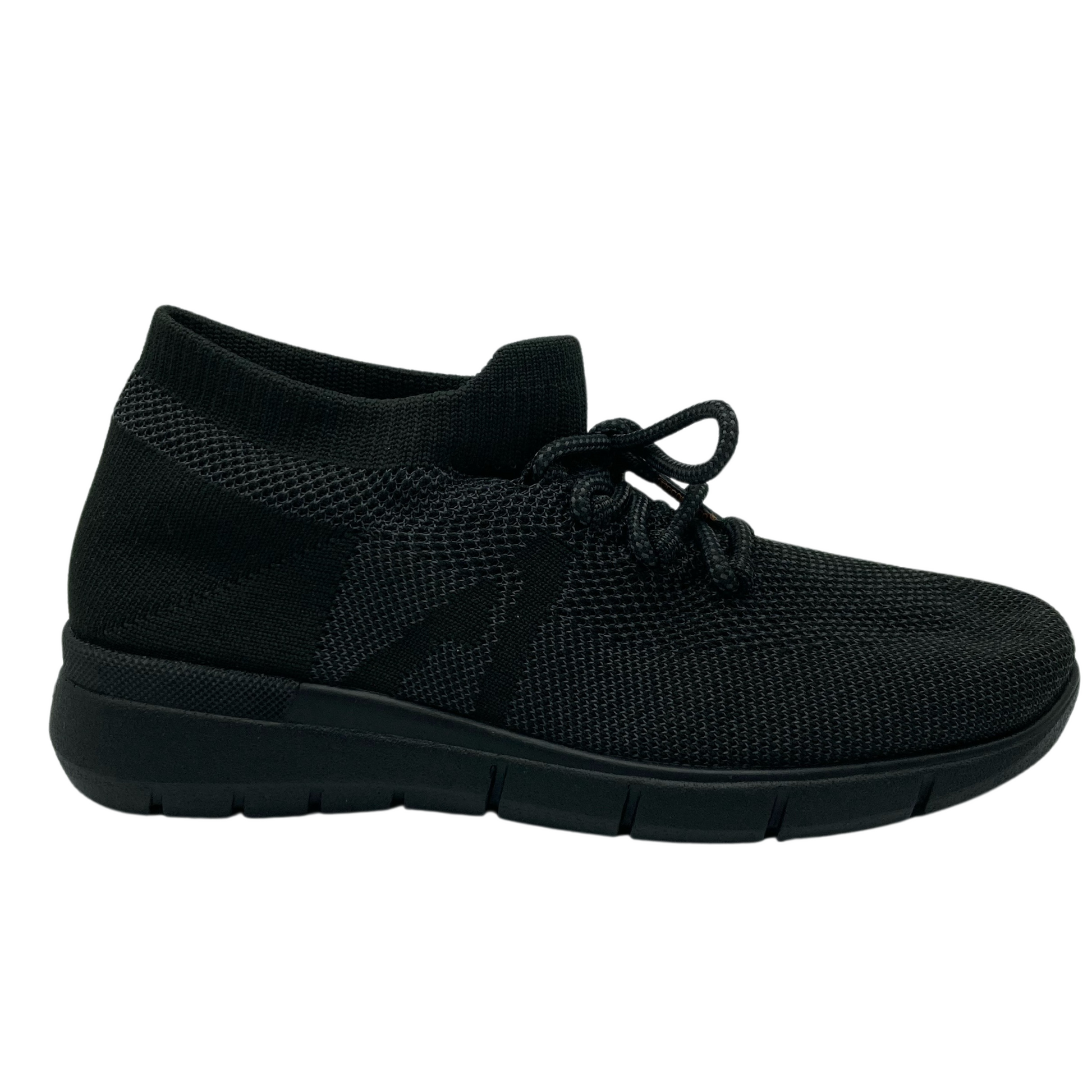 Right facing view of black mesh sneaker with black outsole