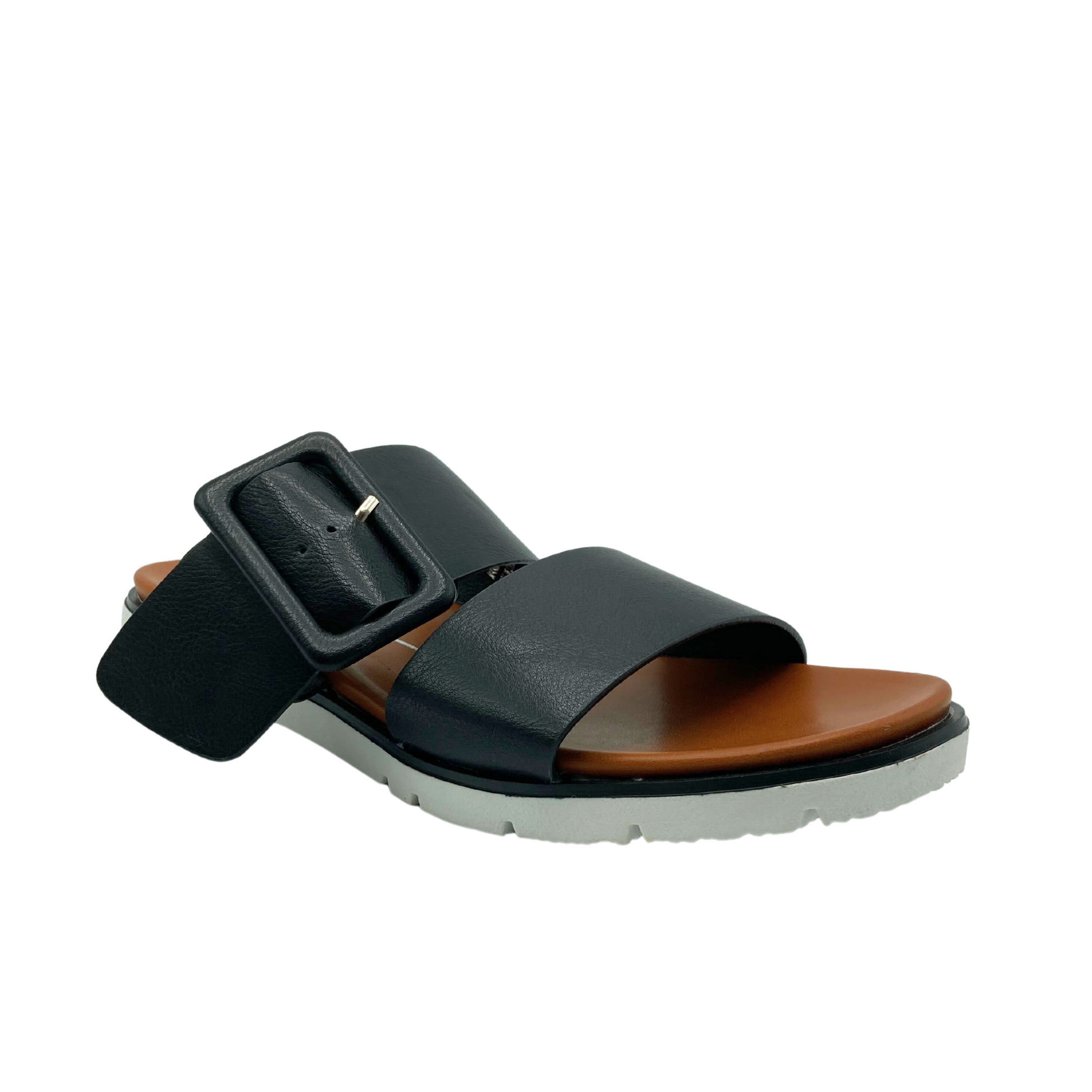Angled front view of a black sandal with two wide straps and an adjustable buckle