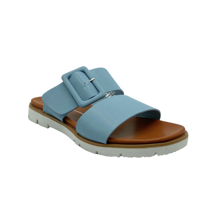 Angled side view of a simple summer slide in a baby blue tone.  Flat with a rugged rubber sole