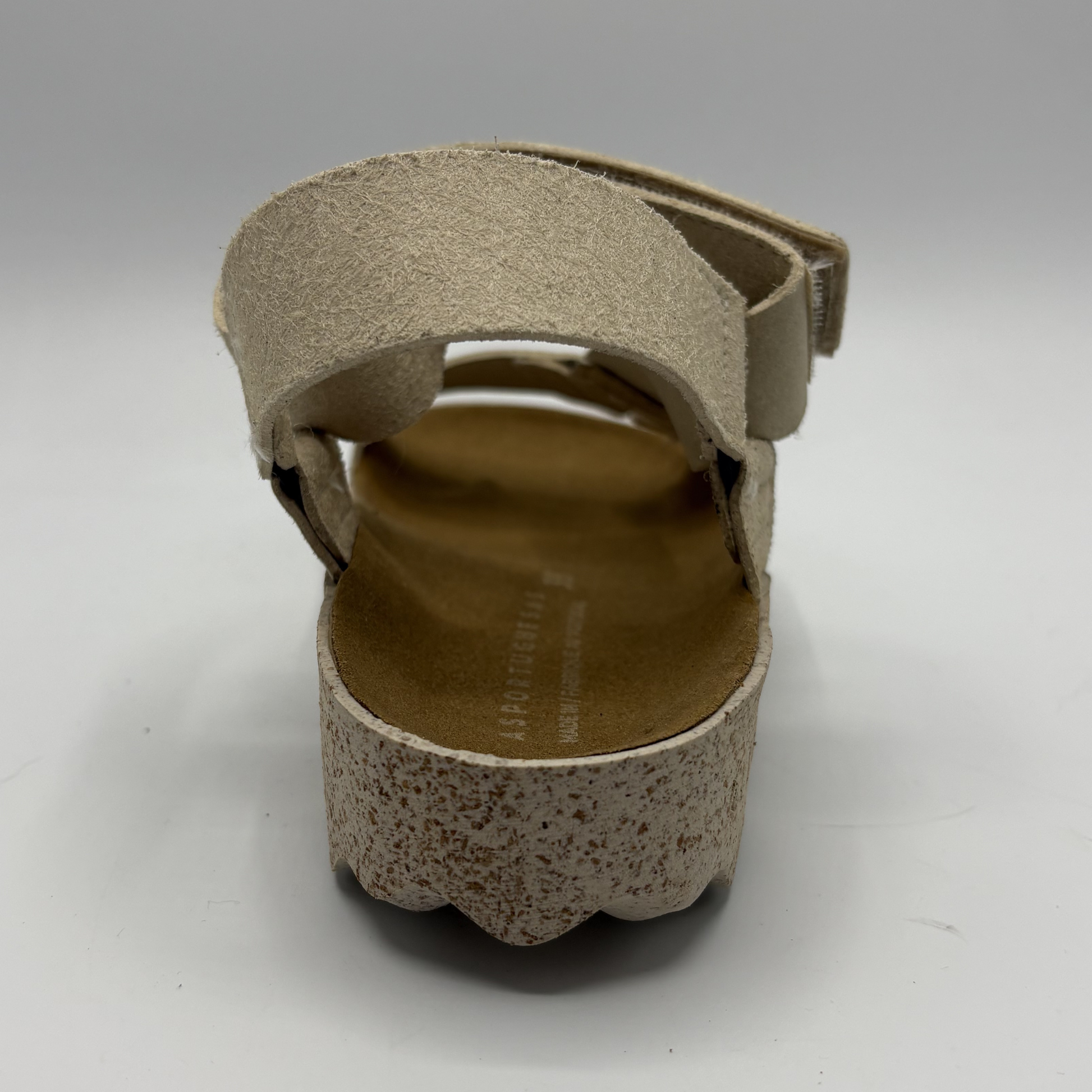 Beige sandal with a strap on a white background