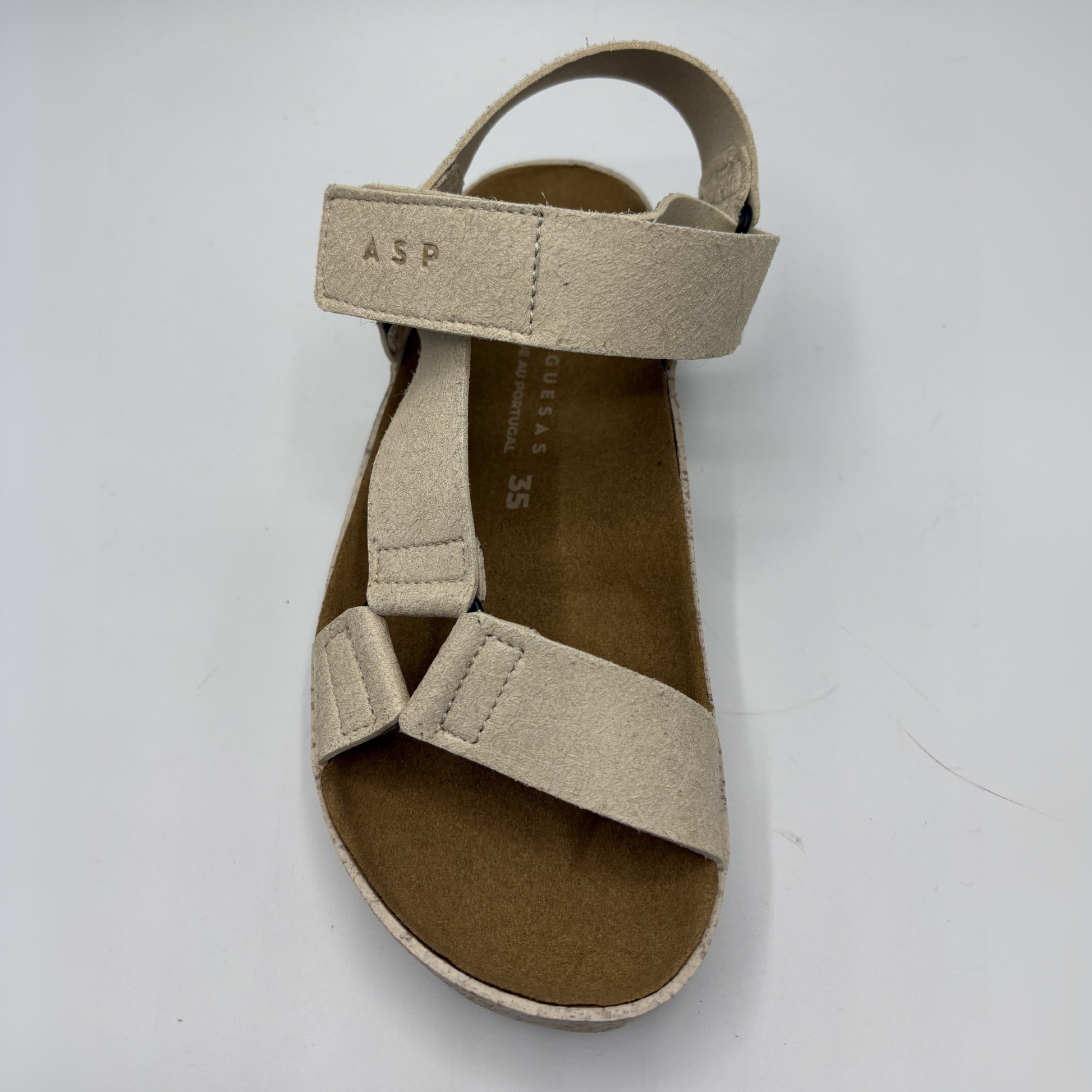 Beige sandal with multiple straps on a white background