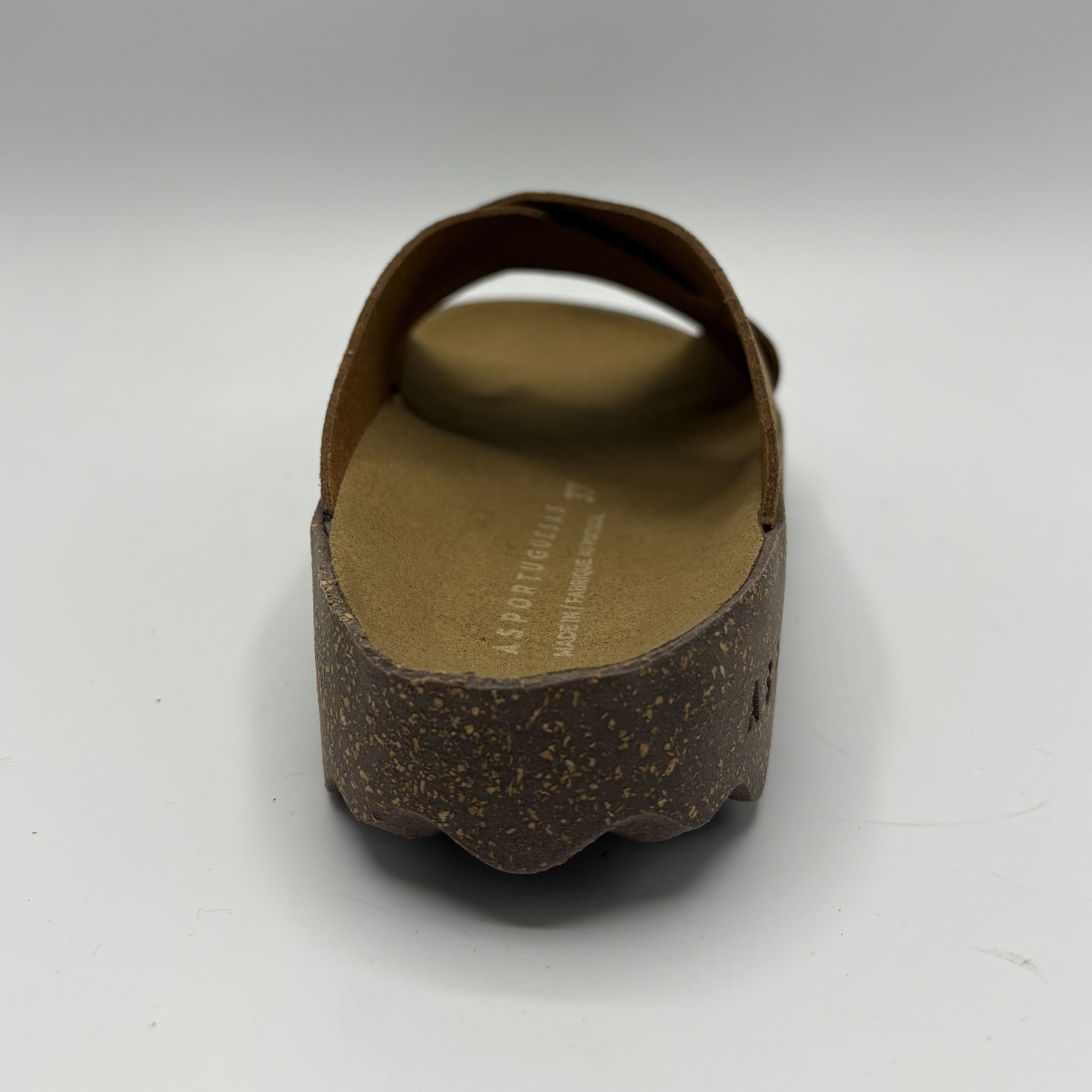 Brown sandal with cork sole on a white background
