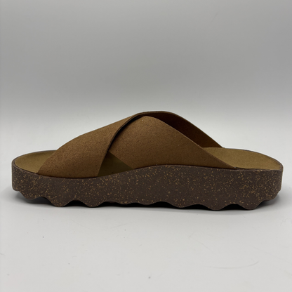 Brown sandal with criss-cross straps on a white background