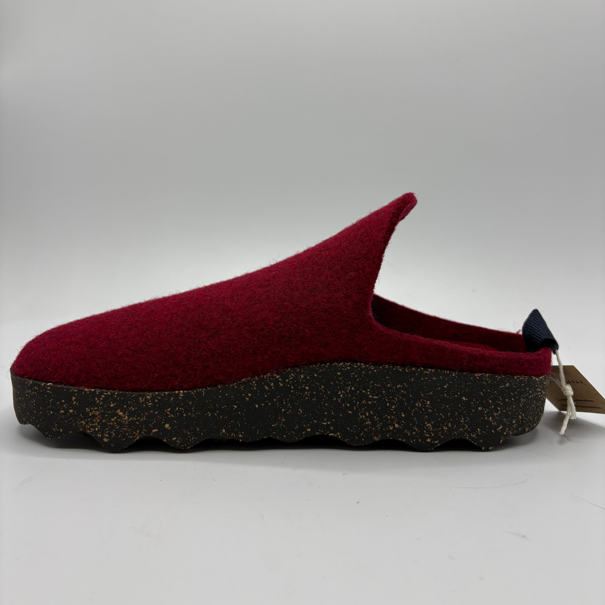 A single slip-on wool mule shoe with a deep burgundy felt upper and a thick, textured black and brown speckled sole, shown against a neutral gray background.