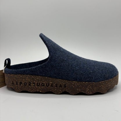 A single slip-on clog shoe made of dark navy blue wool with a brown textured, cork sole, shown against a neutral gray background. The brand name 'ASPORTUGUESA' is embossed on the side of the sole.