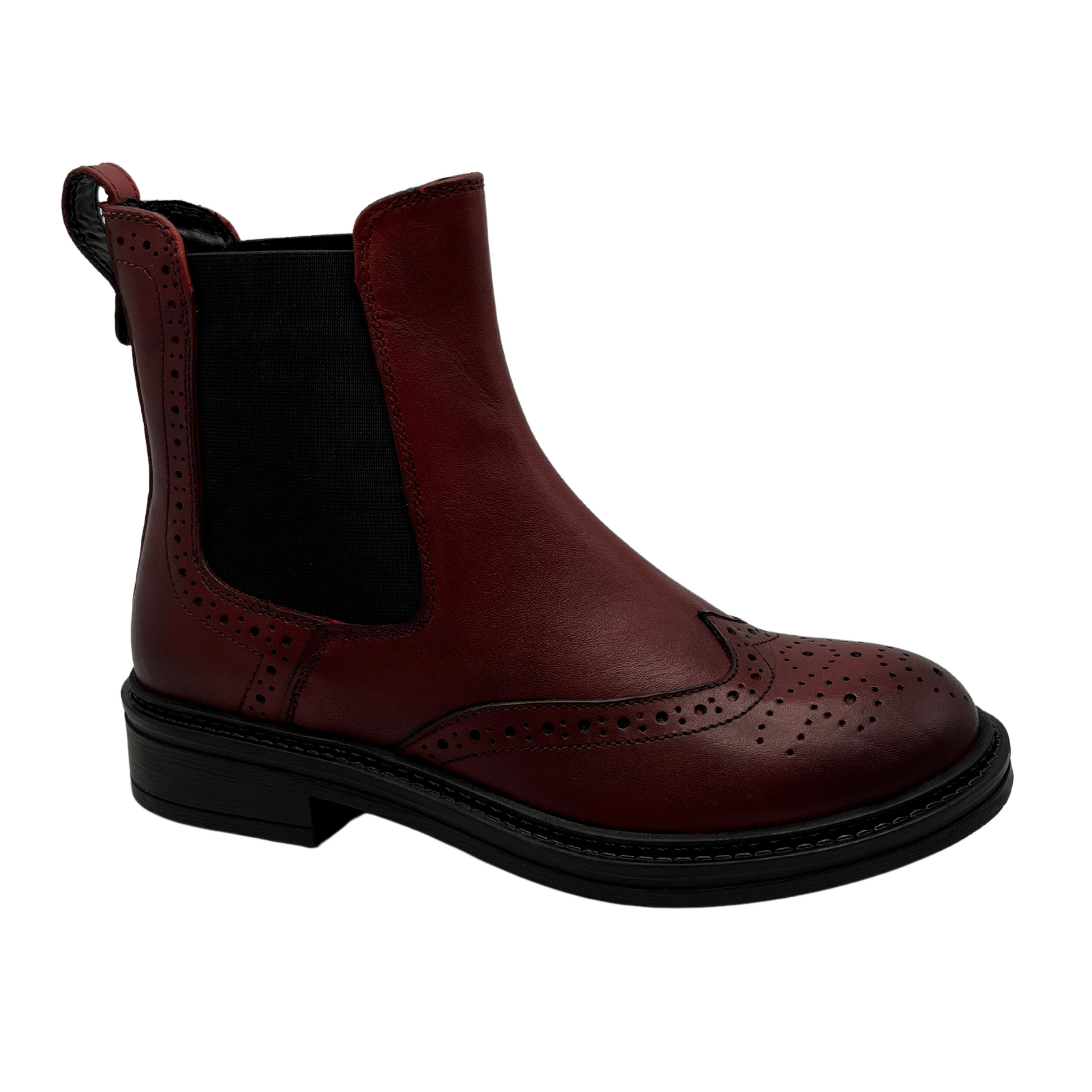 45 degree angled view of red leather short boot in a western style. Featuring elastic side gores, low heel and pull on heel tab.