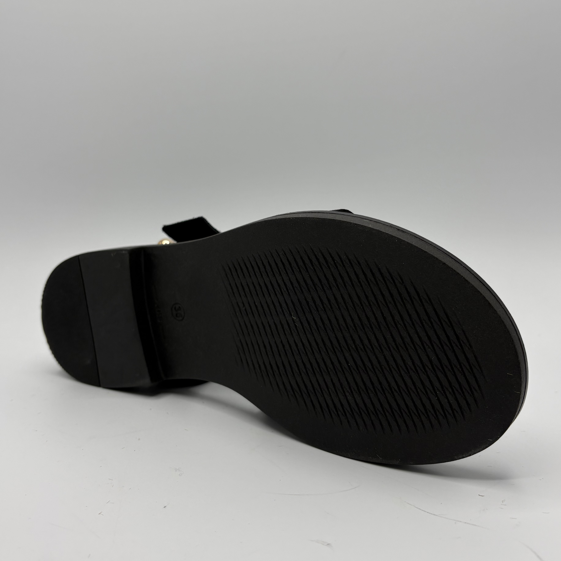 Black sandal sole on a gray background