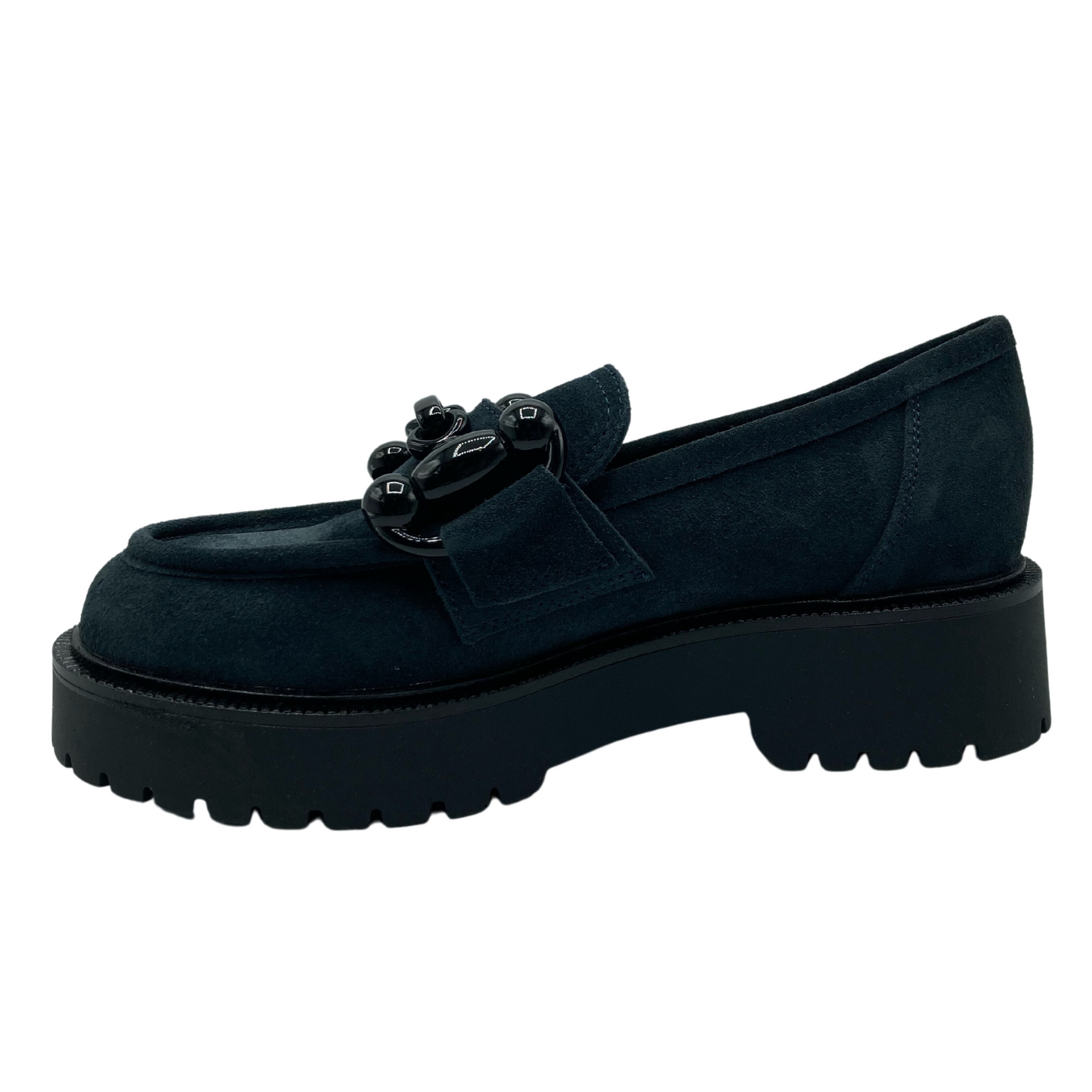 Left facing view of navy suede loafer with black buckle detail on upper and black lug sole