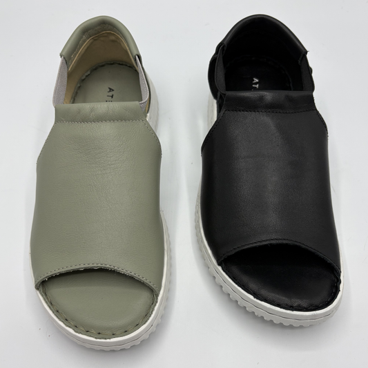 Pair of green and black open-toe shoes on a white background