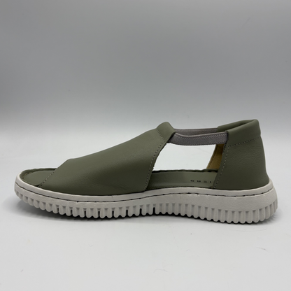 Green sandal with a white sole on a gray background